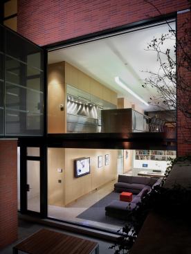 A three-story storage wall serves as an organizing element for every room in the house...