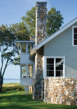 Not only does a stone wall touch the structures as it marks the edges of the built environment, but also a reveal of stone runs along the base of the buildings.