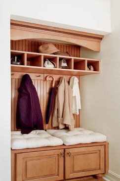 STEPPING OUT: A reclaimed vestibule under the stairs, next to the porte cochere entry, provides a resting place for coats, purses, hats, mittens, backpacks, and shoes.