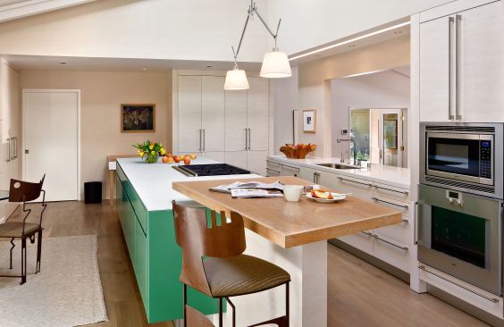 “We cook, eat, watch the news, read the paper, work at the iPad, and read the mail here,” say the owners of their remodeled kitchen. Work spaces of varying heights make it all possible. Project: Ranch Updated, Sacramento, Calif.; Architect: Carver + Schicketanz; Builder: Otto Construction