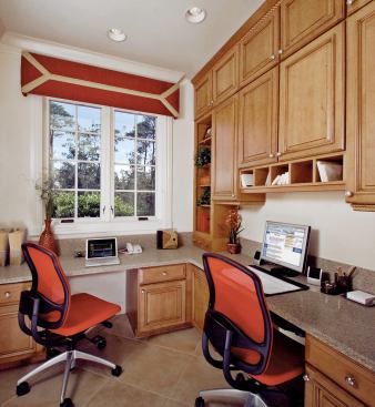 MULTITASKING HEAVEN: Built-in cabinetry and an Lshaped countertop fuse maximum efficiency into a small home office space next to the rear staircase and within earshot of the family room.