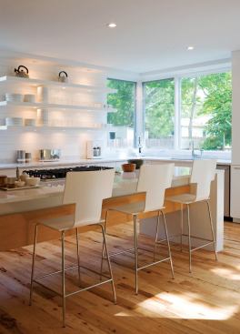 The kitchen's design allows for countertop-to-ceiling windows that bring in backyard views.