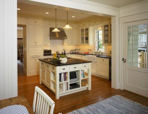 Kitchen countertops are honed granite. Storage cabinets around the high ceilings and throughout the large center island maximize space. The kitchen designer was Glenda Powers of Bethesda Design Group.
