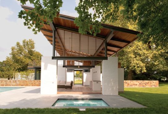 The copper roof tilts up toward the Rappahannock River, and a deck above the bedroom suite is a point of prospect.