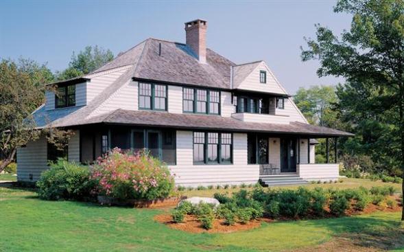 A spread-out stance and broad, sheltering roof settle the building comfortably in its site. (Left and below) The sparsely trimmed interior was inspired by utilitarian Shingle-style kitchens and carriage houses.