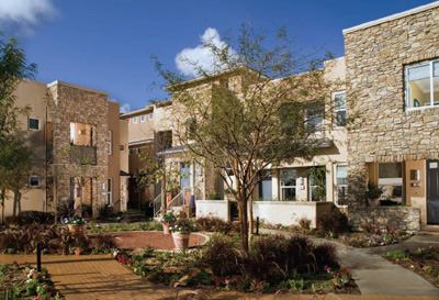 With their parapet walls and stone fa&ccedil;ades, the courtyard homes share a common language with the commercial structures in the valley, and yet this enclave has the intimacy of a small village, thanks, in part, to gardens and green spaces carved into the lap of each building plan.