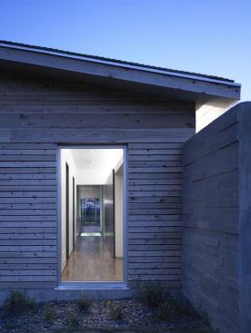 Two patterns of local cedar siding, plus a band of wider boards at window-head height, lend variety to the exterior wall surfaces.