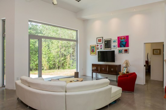 An oversized aluminum-framed window lets natural light fill the "living" space in the core of the house.