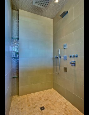 Niche shelves in the shower provide space for bath items. 
