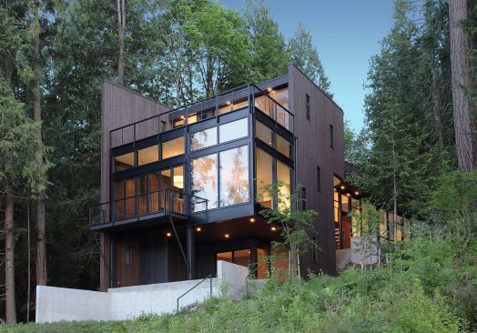 Walls clad in tight-knot cedar channel siding provide privacy and link the house to surrounding trees. Location: Snohomish, Wash.; Architect: David Vandervort Architects