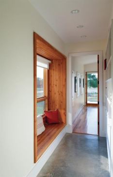 This built-out window’s glulam interior frame makes for a cozy alcove along the hallway connecting the kitchen to the master bedroom in this Texas ranch-house remodel. The window daylights a previously dark space while its bench complements the recessed bookcase installed in the opposite wall.  Builder, June 2013  
Residence, Texas  Furman + Keil Architects, Austin, Texas