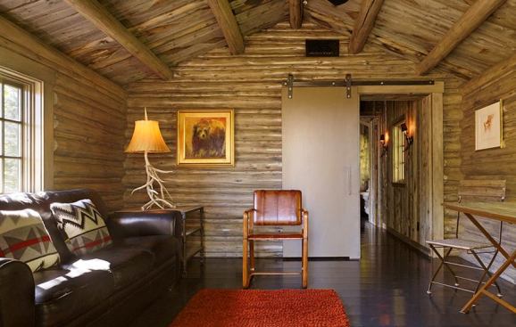 The original cabin is used as an open living area with a small kitchenette.