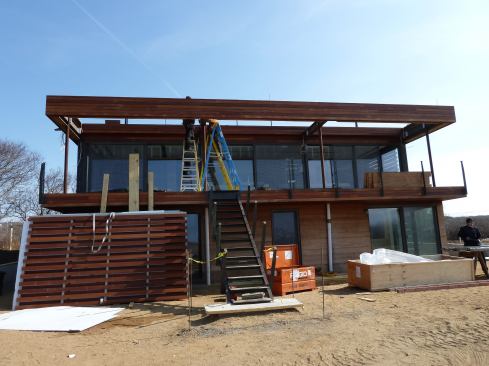 Sliding shutters will serve as sun shades, storm protection, and a way to close up the house in the off-season.