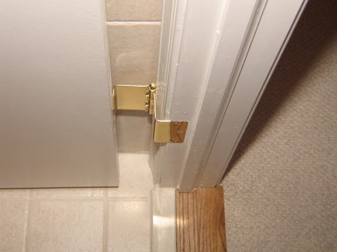 We unscrewed the original hinges and screwed-in the new ones, using the same holes and mortises.