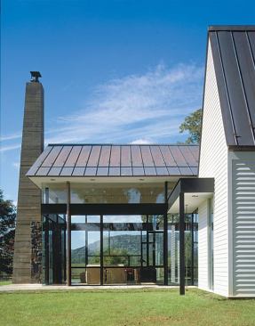 The glass pavilion's transparency prevents it from upstaging the original farmhouse.