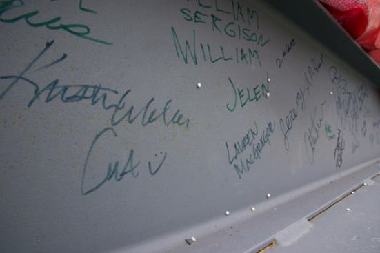 Student signatures on one of the steel members that supports the frame of Harvest House.