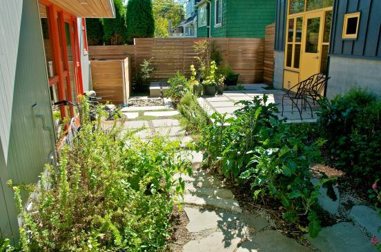 The laneway house (right) is tucked up to a 2-foot rear yard setback and creates a private courtyard with the main house.