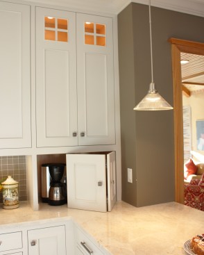 After shaking up the plan by moving walls, eliminating doors and enlarging the window, the new space was furnished with finely tailored cabinetry, quartzite tops and a custom built range hood as the focal point.