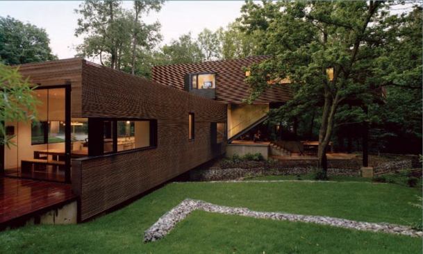Stacking the two volumes created a covered terrace at the rear of the house. A teak deck off the dining area provides another outdoor room.