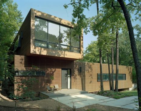 The second floor juts out over the home's entry, supplying shade and shelter to the welcoming front porch.