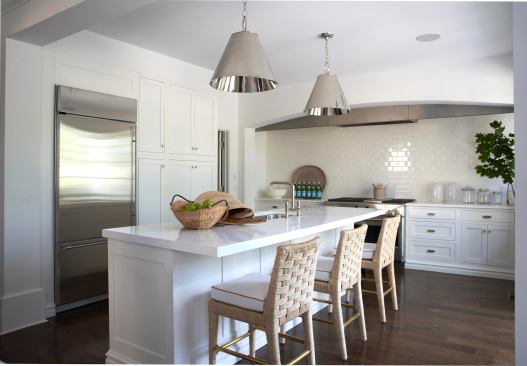 Elegant touches such as stainless steel appliances, marble countertops, and a white tile backsplash make the kitchen a standout.