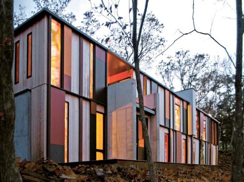 A 4-foot post-and-beam structure suports the vivid exterior grid. The two-story side of the house looks out through the treetops and onto Green Lake.