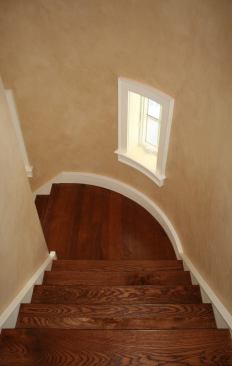 Shot before the rails went in, this shot shows that client didn’t want a grand, curved stair. Instead, the stair is tucked off to the side. It's 4 feet wide, and the flooring and treads are white oak. The walls are painted in a faux finish meant to resemble limestone, and the back stair was done in a similar fashion.