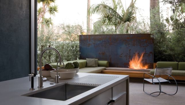 Interior elements deploy an abbreviated palette of materials in broad, simple forms. A plate of cold-rolled steel serves as a backdrop for the patio's gas fireplace.
