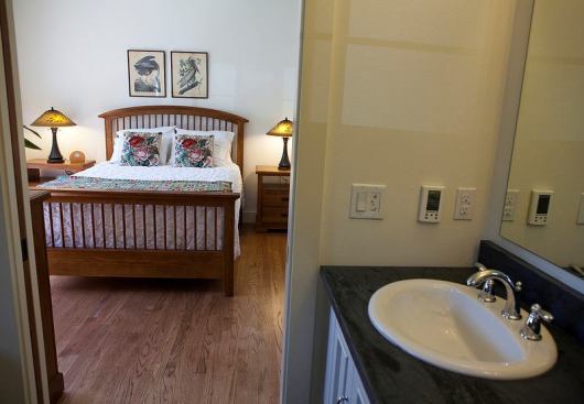 A pocket door separates the first-floor master bedroom from the ADA-compliant bathroom. The doorway is wide enough to admit a wheelchair if necessary.