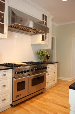 This farmhouse had received several updates and renova-
tions over the years. However, the floor plan was conflict-
ing amongst the kitchen, laundry, mudroom, and powder 
room. A complete reorganization of the first floor was 
achieved through multiple structural changes that al-
lowed for a larger kitchen and created better flow be-
tween adjacent rooms. The kitchen includes custom 
painted cabinetry, a farmhouse style sink, and soapstone 
countertops. A commercial size Viking range, hood, and 
Sub Zero refrigerator bring a theme of stainless steel to 
the kitchen which is accentuated by brushed nickel hard-
ware and island faucet. Specialty lighting, glass door 
cabinets, and a grand, eight foot island are just a few of 
the features that make this kitchen stunning.