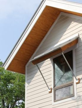 Deep roof overhangs, awnings, and porches help block direct sun exposure, which reduce heat load and keep the house cooler.