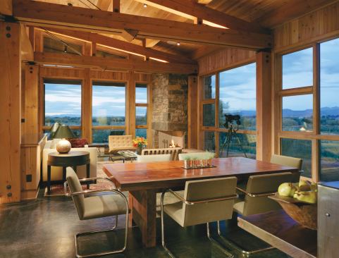 A shed roof translates into a sloping, wood-lined ceiling inside. Exposed trusses keep the scale of the main living spaces from feeling overwhelming.