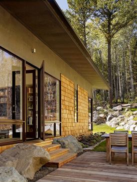 The guest house uses cross-ventilation, solar orientation, and overhangs as additional passive cooling strategies.