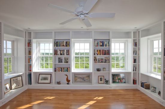 Custom bookcases line the walls of the second-floor library.
