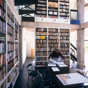 A two-story home library is the central space in this water tower cum residence.