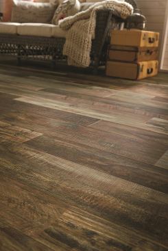 Armstrong Laminate flooring has an inner core made from wood fibers, but it is the photo-realistic image on what Armstrong calls the design layer that captures the essence of genuine wood. With eight color choices, the Architectural Remnants line mimics the look of reclaimed wood. The 12mm laminate features the firm’s VisionGuard wear layer to protect from staining, fading, and wear. 
Prices start at roughly $3.50 to $5 per square foot.