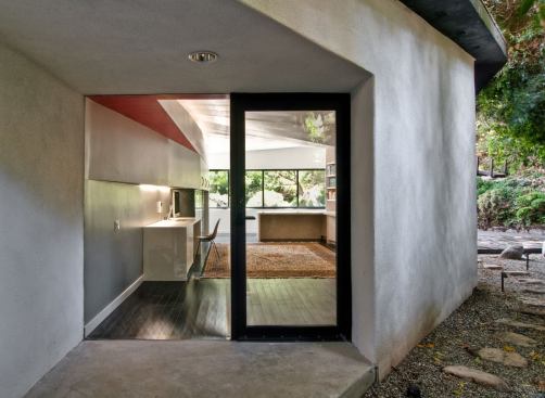 A second egress connects to the back gardens. The library's dark bamboo floors fit with the Asian-inspired landscpaing.