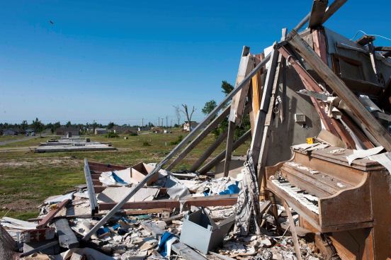 Most of the damage and debris in Joplin has long since been cleaned up, but a few houses still stand in their wrecked condition, a jumble of ruined structures and abandoned possessions. Here, a piano sits amid splintered framing in an older neighborhood near the high school.