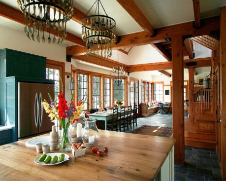 The house gets its time-worn appeal from use of materials like stone on the floor and repurposed timber beams. Pieces of archtiectural salvage appear throughout the house.