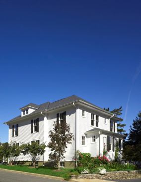 "The owners wanted a larger, better house, but didn't want to destory the integrity of the old one in order to achieve their goals," says Moore. Because the house was salvaged, not demolished, the builder and architect were able to obtain a zoning variance.