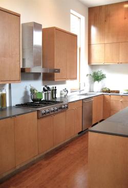 Warm wood floors and walls soften the bright natural light that floods the room.