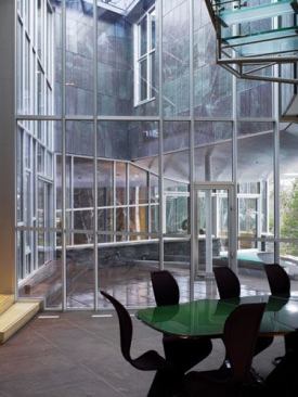 The glass-lined courtyard holds a stainless koi pond.