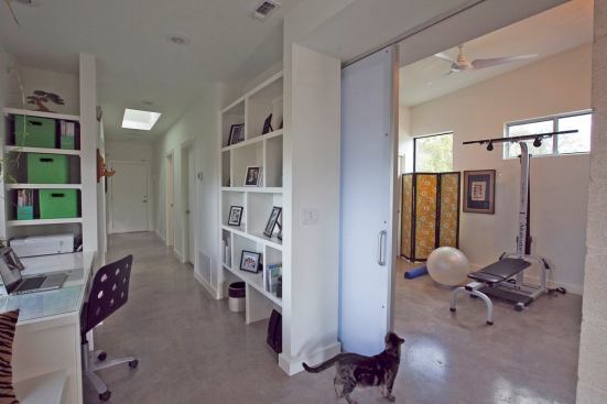 The hallway circulation is outfitted with built-in desk and storage spaces. As a result, the space doubles as an office.