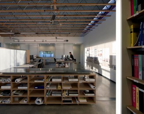 The open interior’s skylights and exposed structure offer both light and shade.