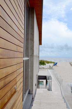 A perch on the top of the exterior stairs shows the house's enviable access to the beach.