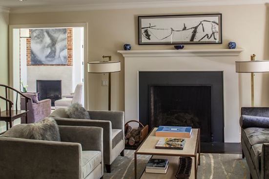 The living room was renovated to include an improved fireplace and larger leaded glass windows. A large opening connects the living room to the family room beyond and creates a smooth, easy flow of spaces.