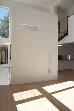 Stair+screen+wall+supports+the+custom+steel+stair+and+has+cutouts+to+allow+light+and+selective+views+between+the+double+height+living+space+and+foyer.+