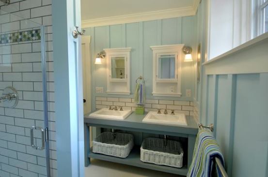 As part of a larger addition, the owners wanted to create a kid-friendly bathroom on a limited budget. Pottery Barn cabinets are framed to appear built in. On the walls, 1x2 batts over an MDF sheetgood create a batt and board effect. Calming hues of blue, green, and charcoal complement the existing home's early 1900's charm.