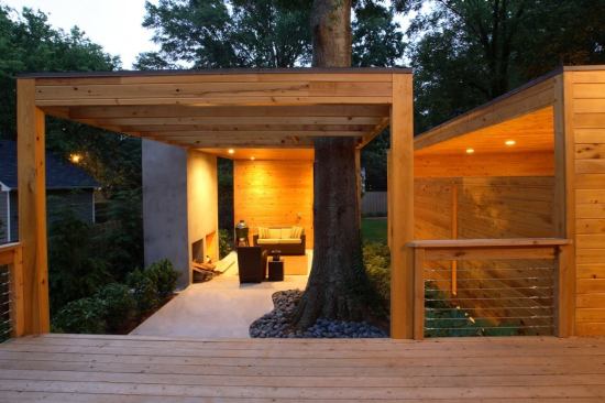 The roof structure and slab work carefully around the trunk of a mature water oak.