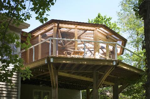 Because the home is on a steep, wooded lot, the platform is 17 feet above grade. It is supported by 8-foot by 8-foot treated pine posts, braced with steel tensioning cables and exposed turnbuckles. Brushed aluminum railings have horizontal steel tension cables.